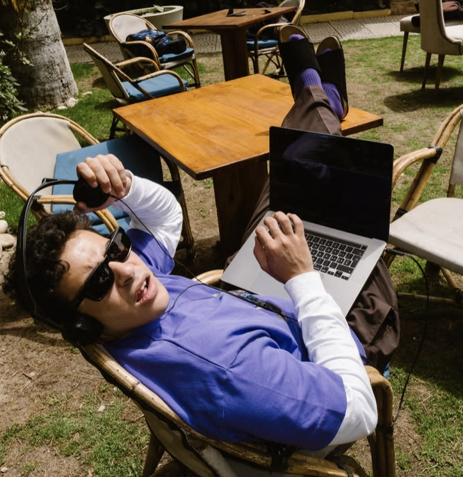 Team member working on a laptop outdoors